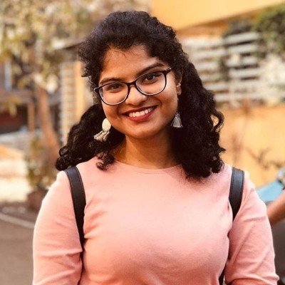 Bhavya smiling in front of camera